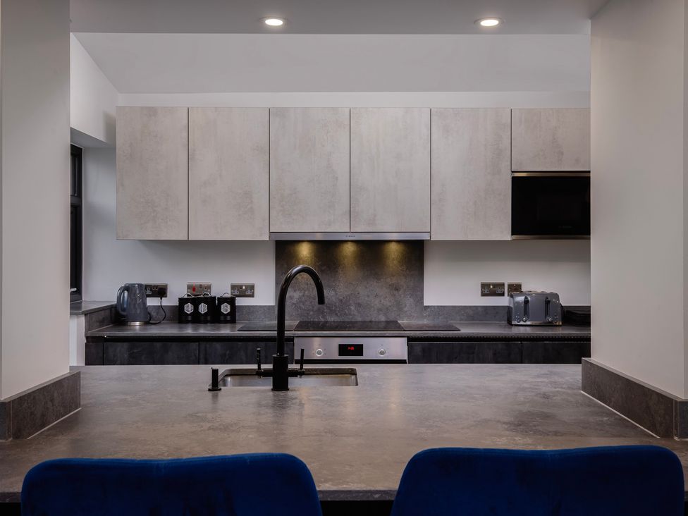 A kitchen with cabinets and appliances at Wind Farm in 