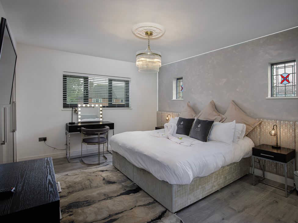 A bedroom with a bed and vanity at Wind Farm in 