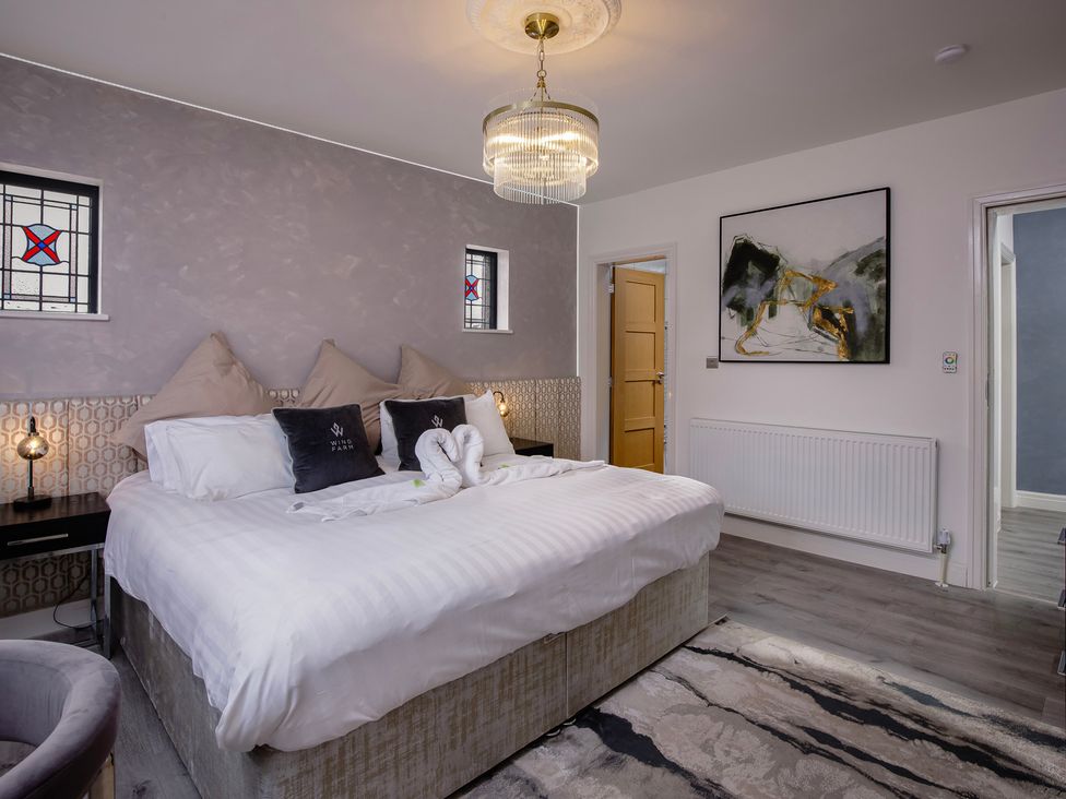 A bedroom with a bed and artwork at Wind Farm