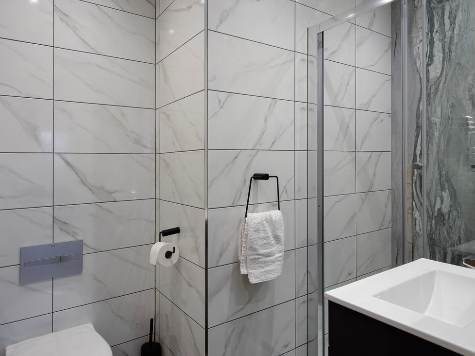 A bathroom with a sink and shower at Wind Farm