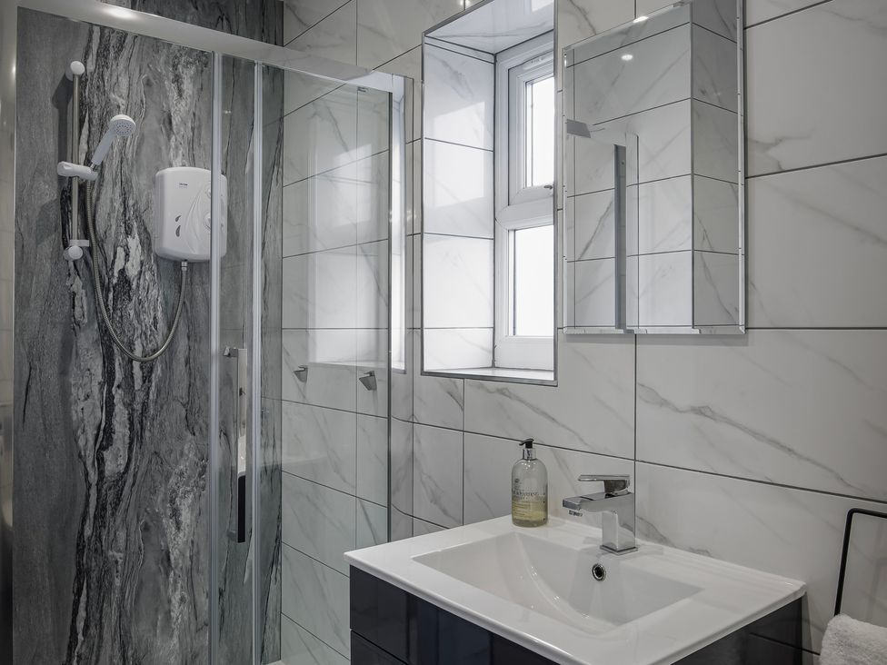 A bathroom with a shower and washbasin at Wind Farm