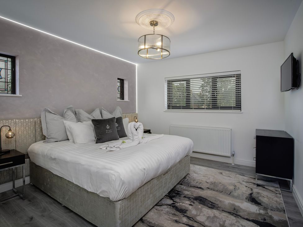 A bedroom with a bed and television at Wind Farm 