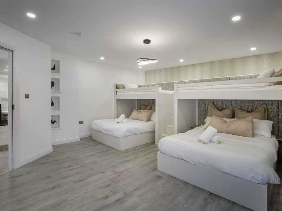 A bedroom with bunk beds and white bedding at Wind Farm 