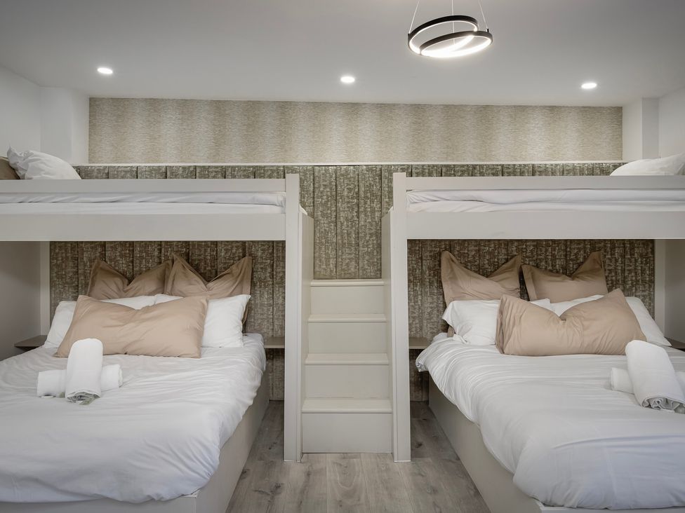 A bedroom with bunk beds and pillows at Wind Farm