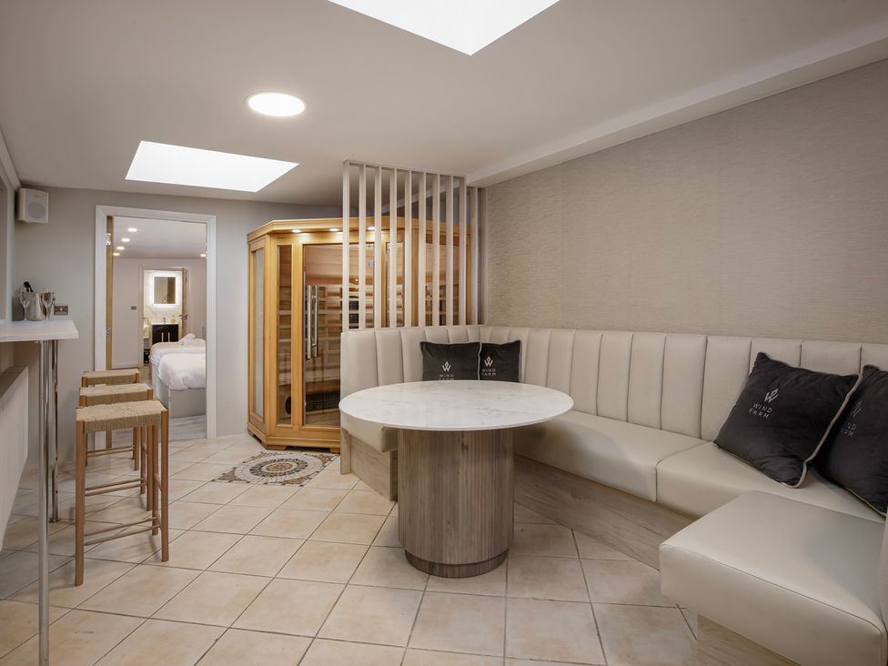 A recreation room with a sauna and seating area at Wind Farm