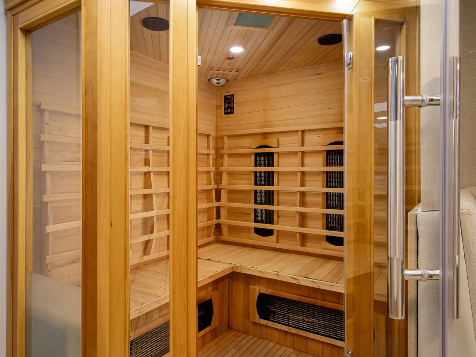 A sauna with wooden benches and a control panel at Wind Farm