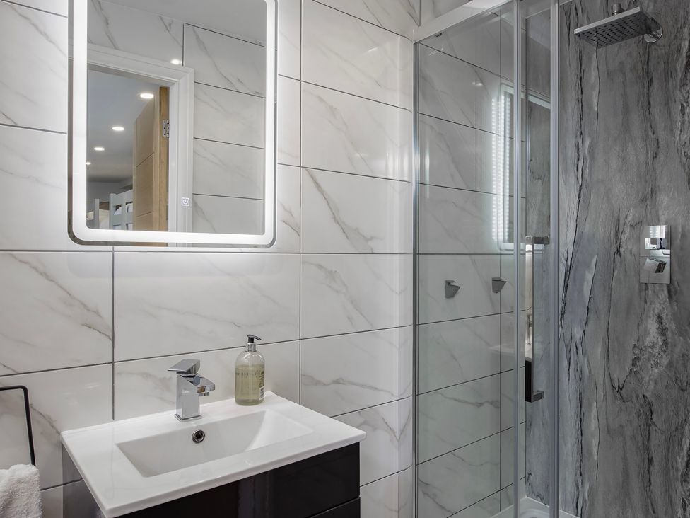 A bathroom with a sink and shower at Wind Farm
