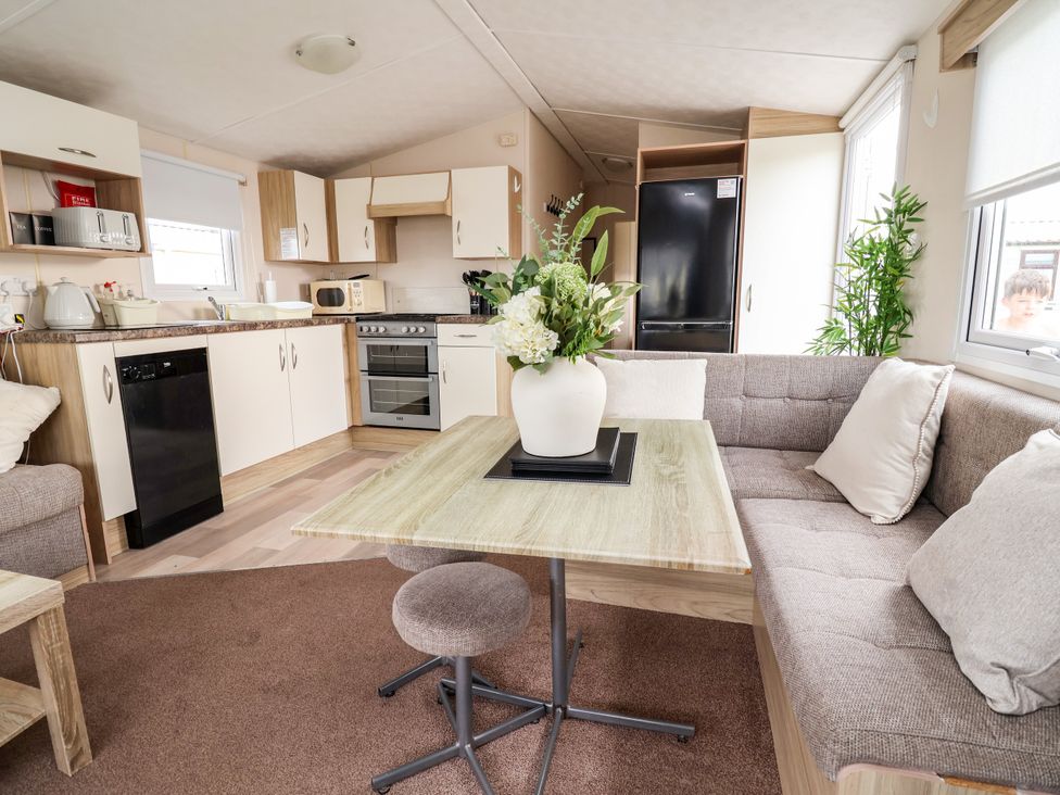 A kitchen with a table and sofa at B54 