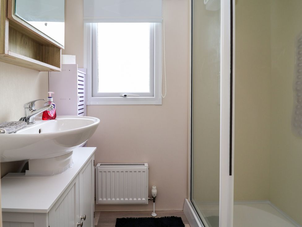 A bathroom with a sink and shower at B54
