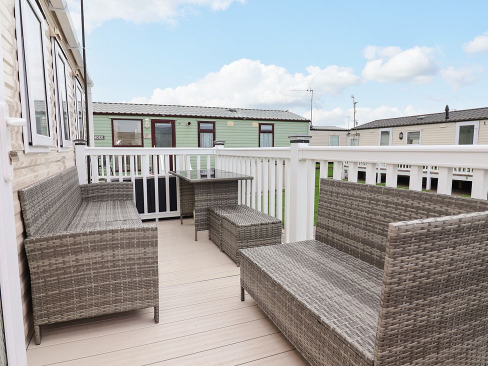An outdoor seating area with wicker furniture at B54