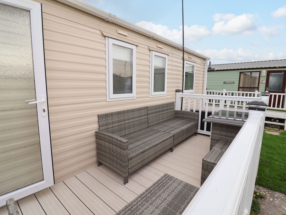An outdoor seating area with a sofa and table at B54