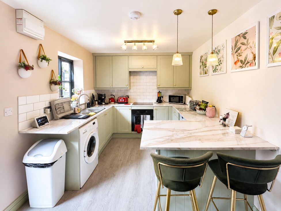 A kitchen with appliances and a countertop at Muddy Boots – La Petite Mews Kirby Stephen