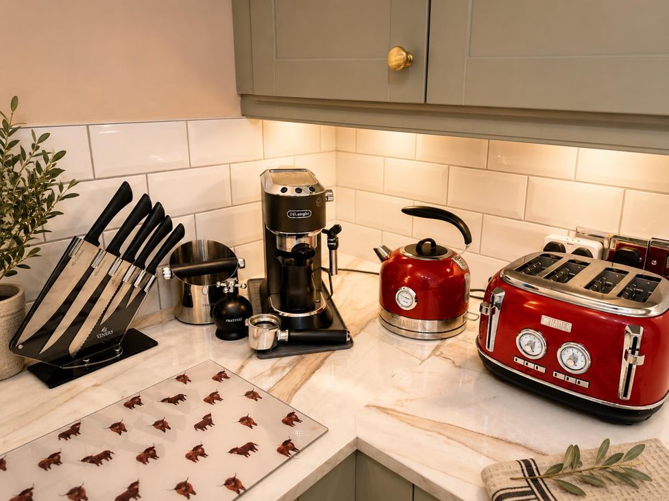 A kitchen with appliances and utensils at Muddy Boots – La Petite Mews in Kirby Stephen