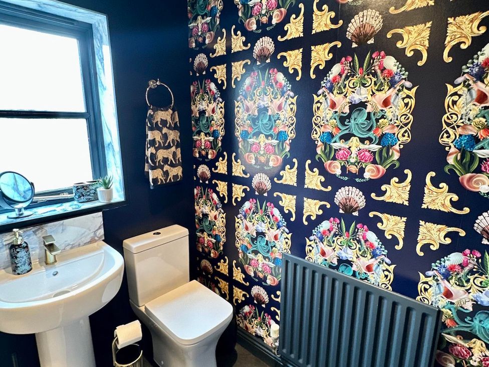 A bathroom with a sink and toilet at Muddy Boots – La Petite Mews in Kirby Stephen
