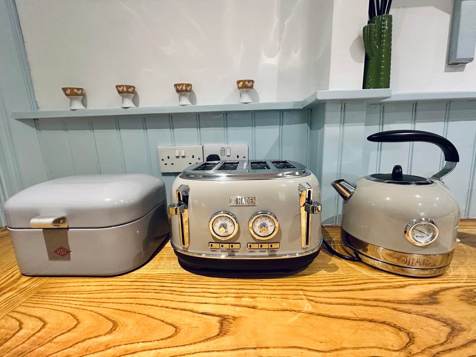 A toaster, kettle, and storage box on a kitchen counter at Muddy Boots – Arcade Royale in Kirby Stephen