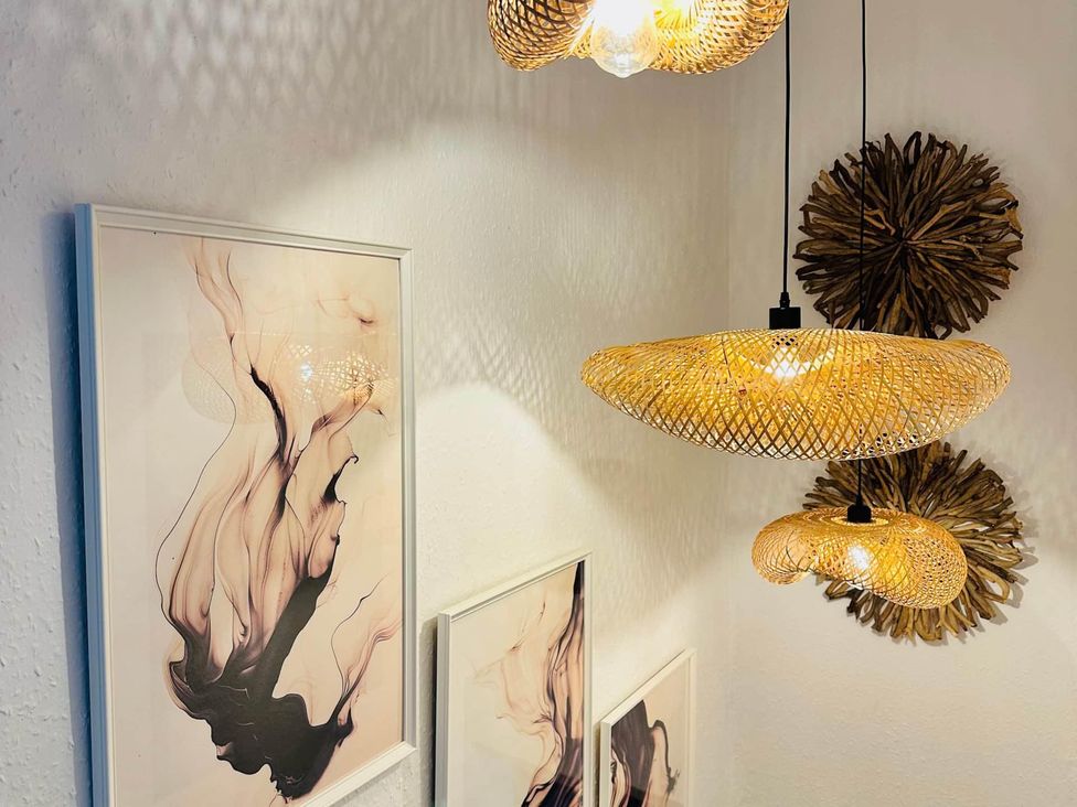 A room with wall art and light fixtures at Muddy Boots – Arcade Royale, Kirby Stephen