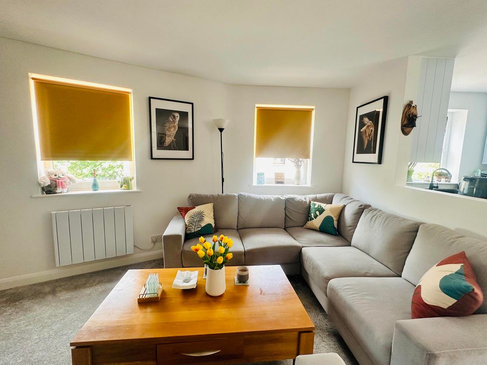 A living room with a sofa and coffee table at Muddy Boots – Scarpa, Kirkby Stephen