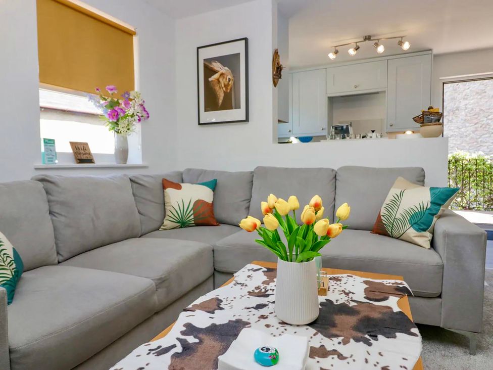 A living room with a sofa and coffee table at Muddy Boots – Scarpa in Kirkby Stephen