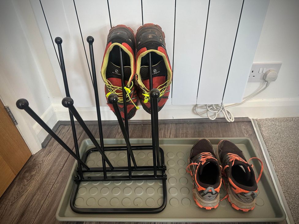 A shoe rack with shoes at Muddy Boots – Scarpa, Kirkby Stephen