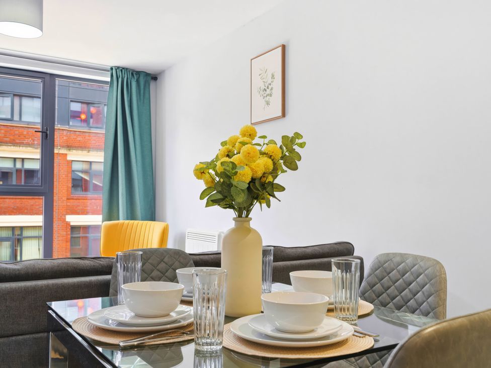 A dining room with a table set for meals at Apartment 56 in Birmingham