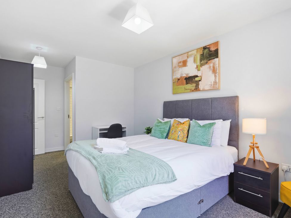 A bedroom with a bed and bedside table at Apartment 56 in Birmingham