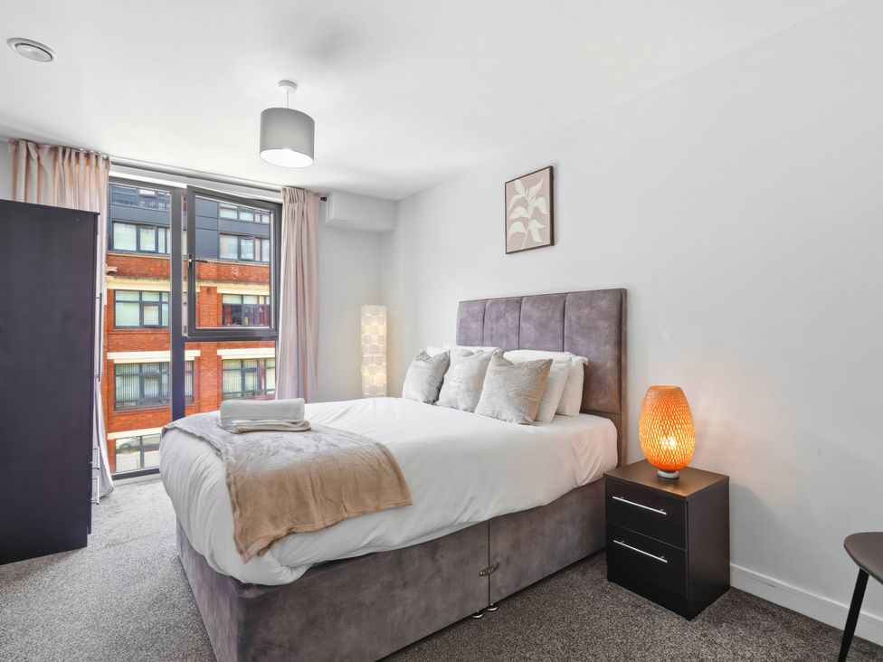 A bedroom with a bed and window at Apartment 56 in Birmingham