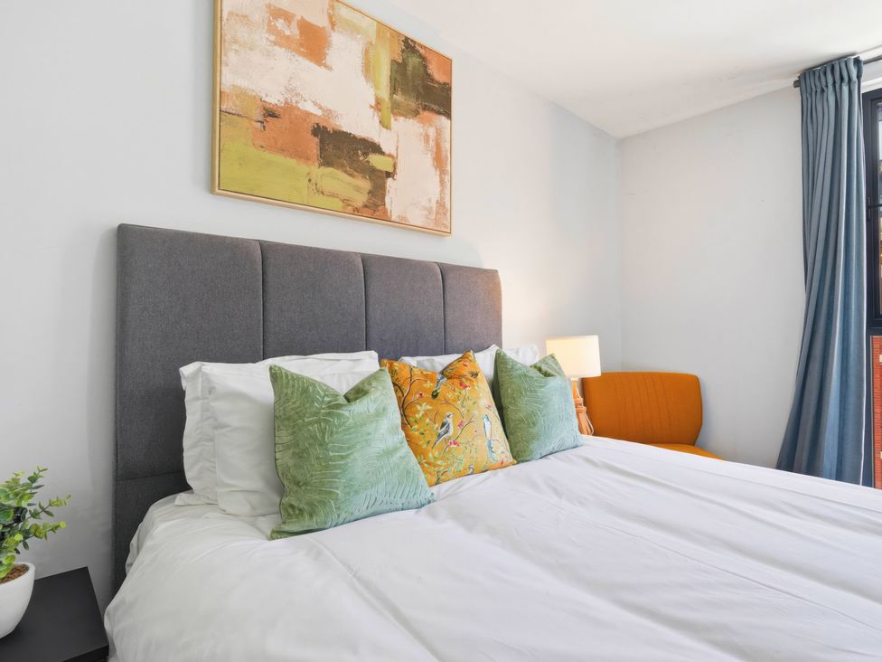 A bedroom with a bed and couch at Apartment 56 in Birmingham