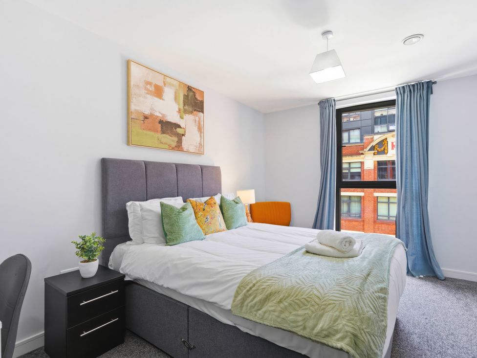 A bedroom with a bed and nightstand at Apartment 56 in Birmingham