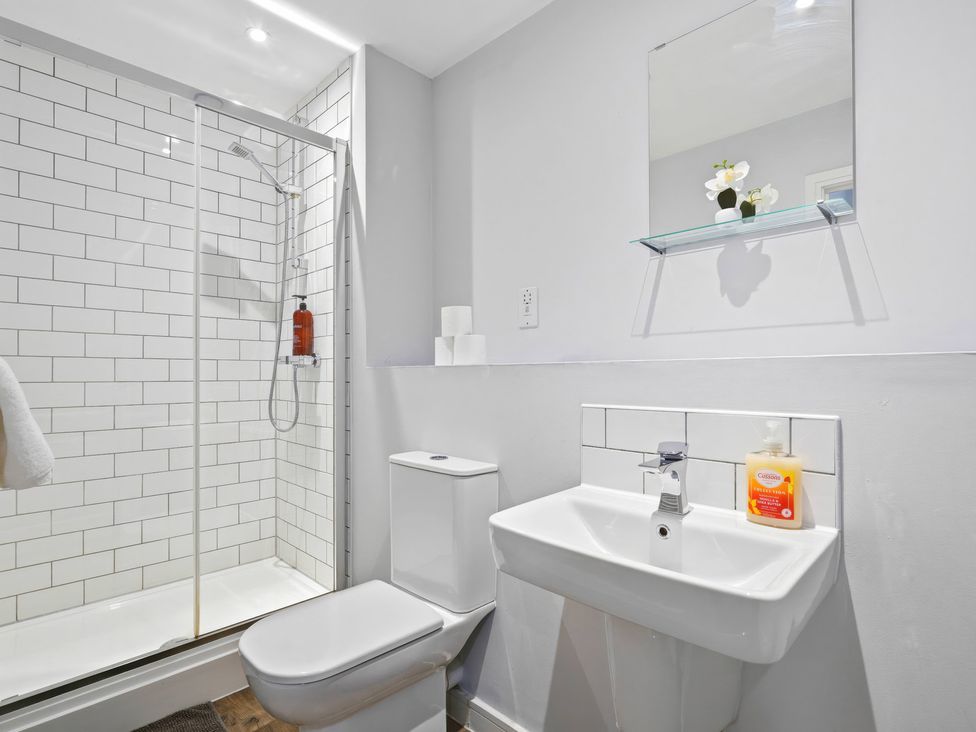 A bathroom with a shower, toilet, and sink at Apartment 56 in Birmingham