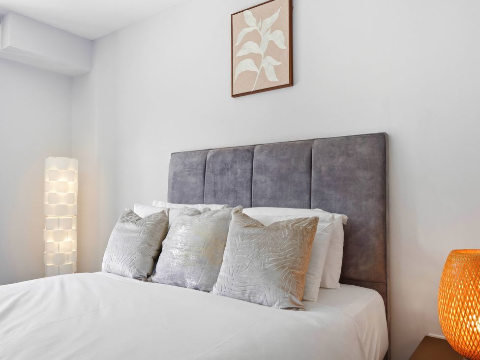 A bedroom with a bed and decorative pillows at Apartment 56 in Birmingham