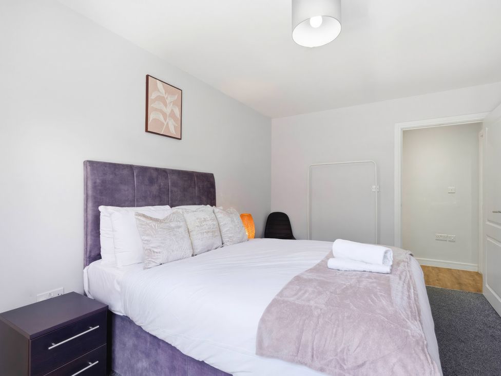 A bedroom with a bed and nightstand at Apartment 56 in Birmingham