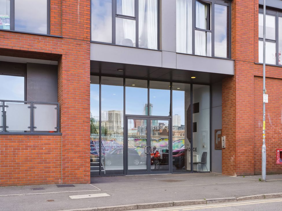 An entrance with glass doors and a balcony at Apartment 56 in Birmingham