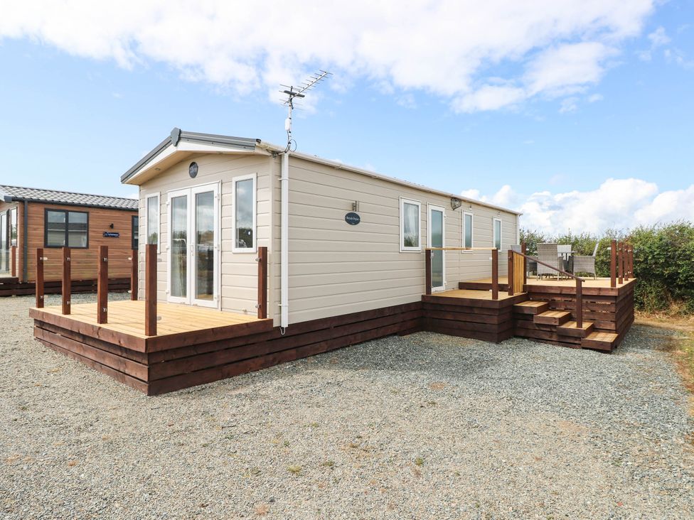 A house with a deck and steps at Seascape in Haverfordwest