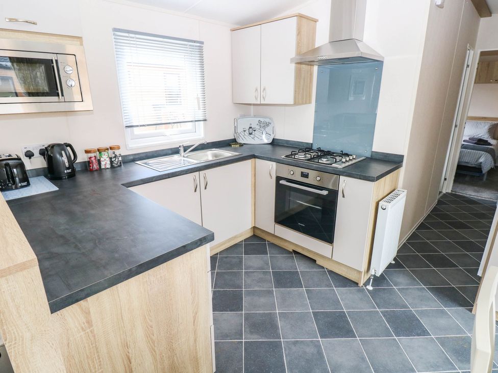 A kitchen with oven and sink at Seascape in Haverfordwest