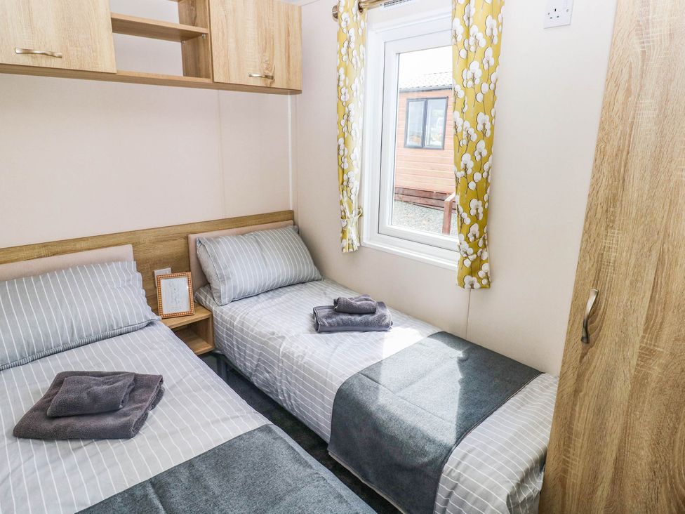 A bedroom with two beds and a window at Seascape in Haverfordwest