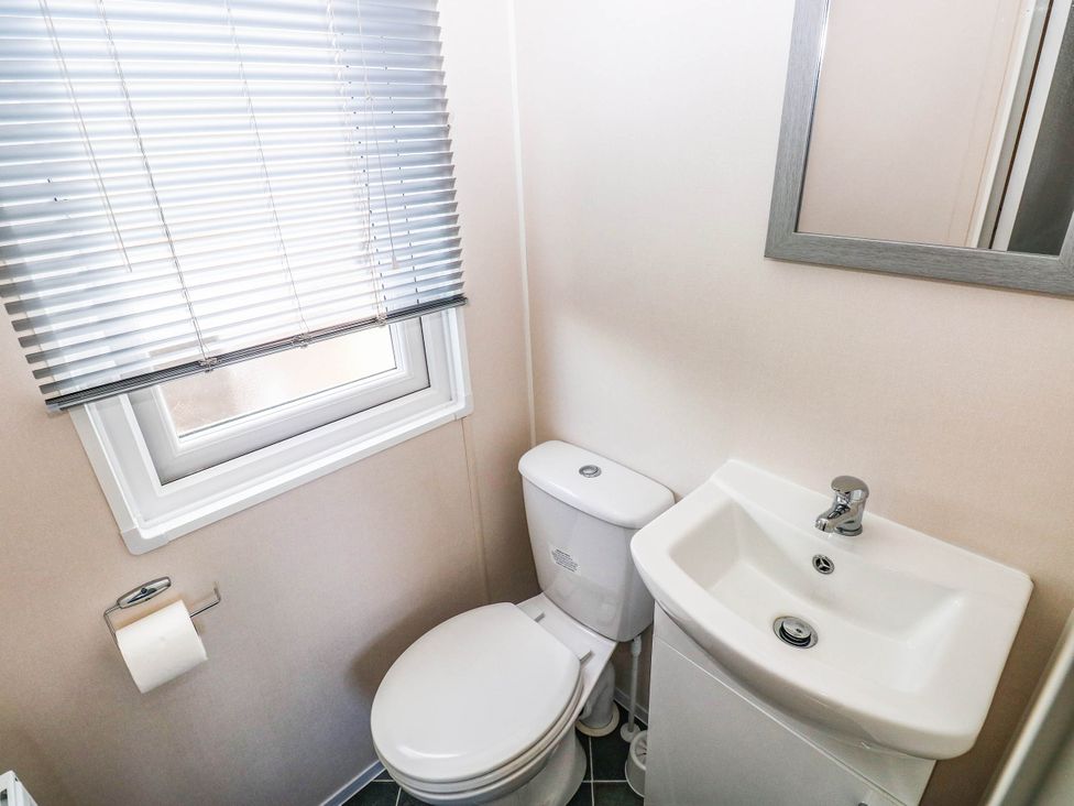 A bathroom with sink and toilet at Seascape in Haverfordwest