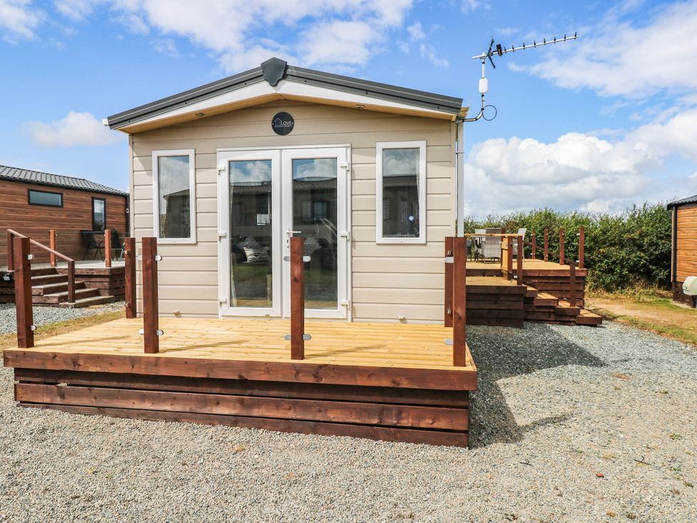 A house with a wooden deck and steps at Seascape in Haverfordwest