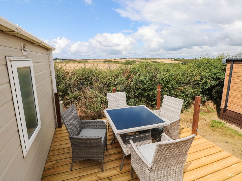 A sitting area with a table and chairs at Seascape in Haverfordwest