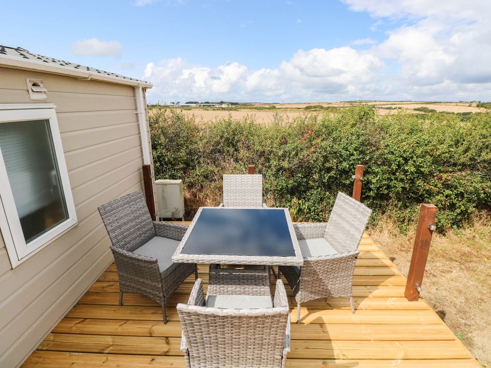 A patio with a table and chairs at Seascape in Haverfordwest