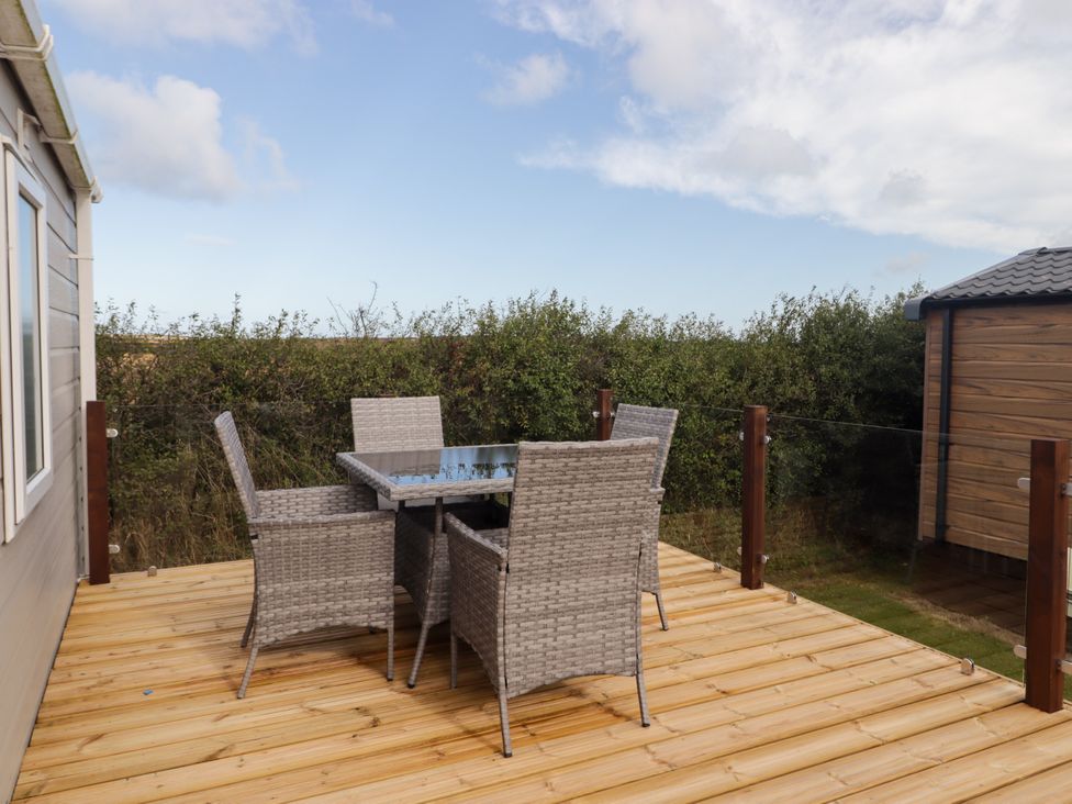 An outdoor space with a table and chairs at Seascape near Little Haven