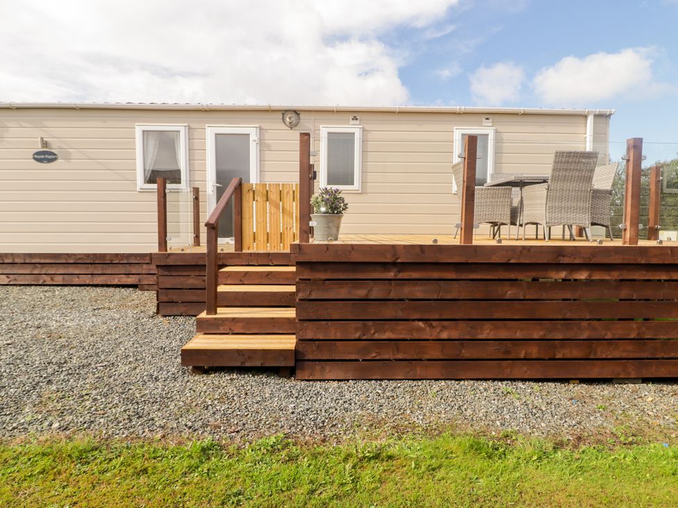 An outdoor area with deck and seating at Seascape near Little Haven
