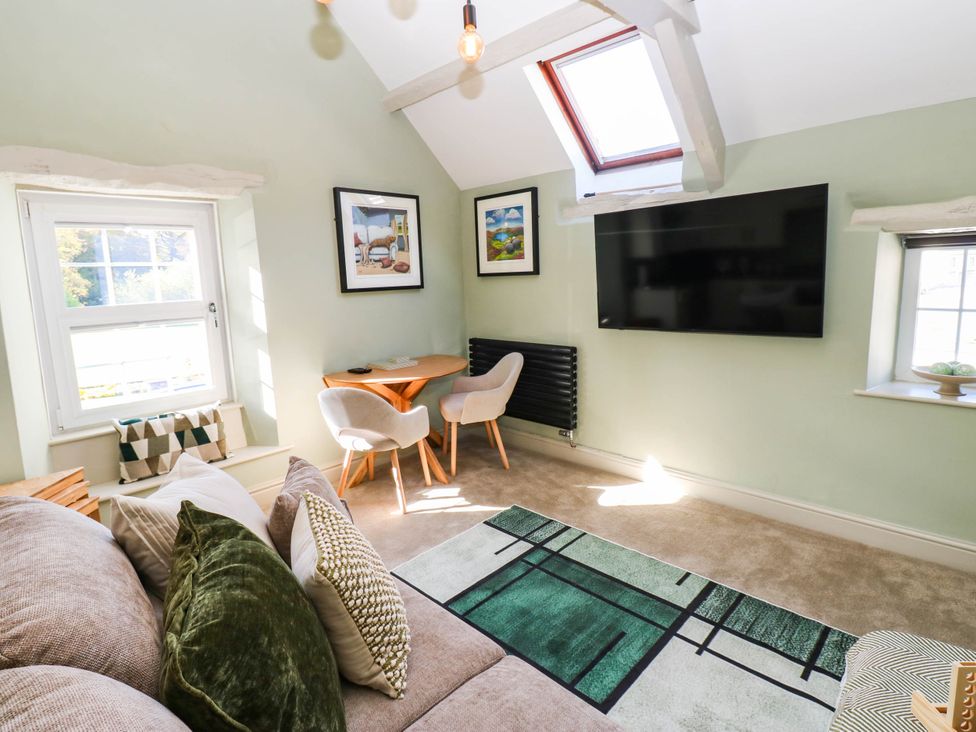 A living room with a sofa and a television at Sands Green in Appleby-In-Westmorland