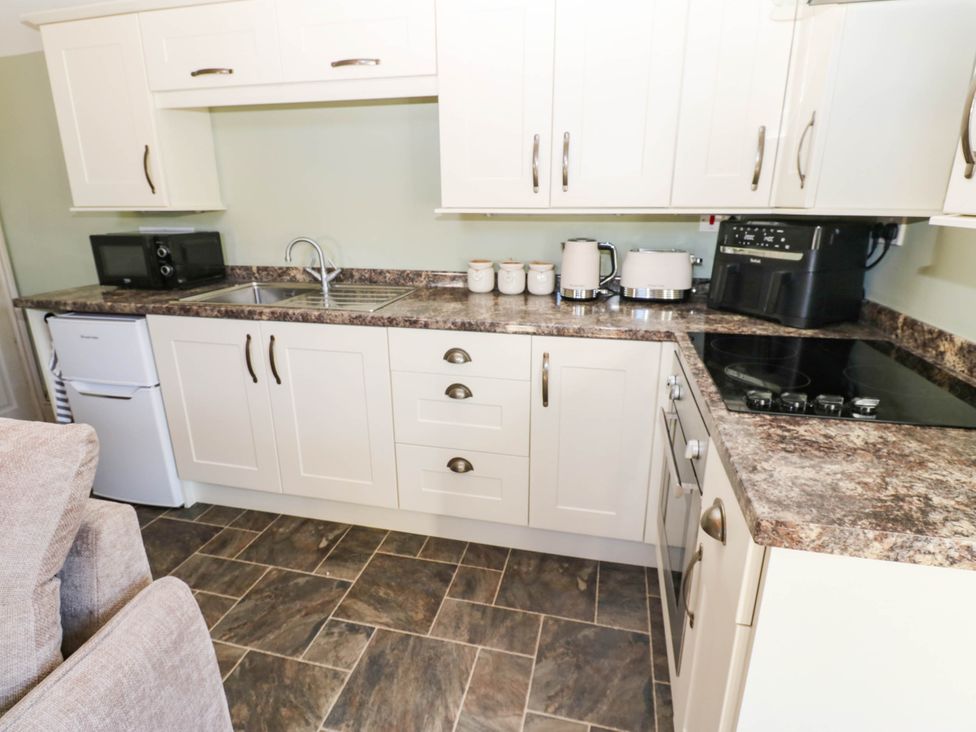 A kitchen with a sink and appliances at Sands Green in Appleby-In-Westmorland