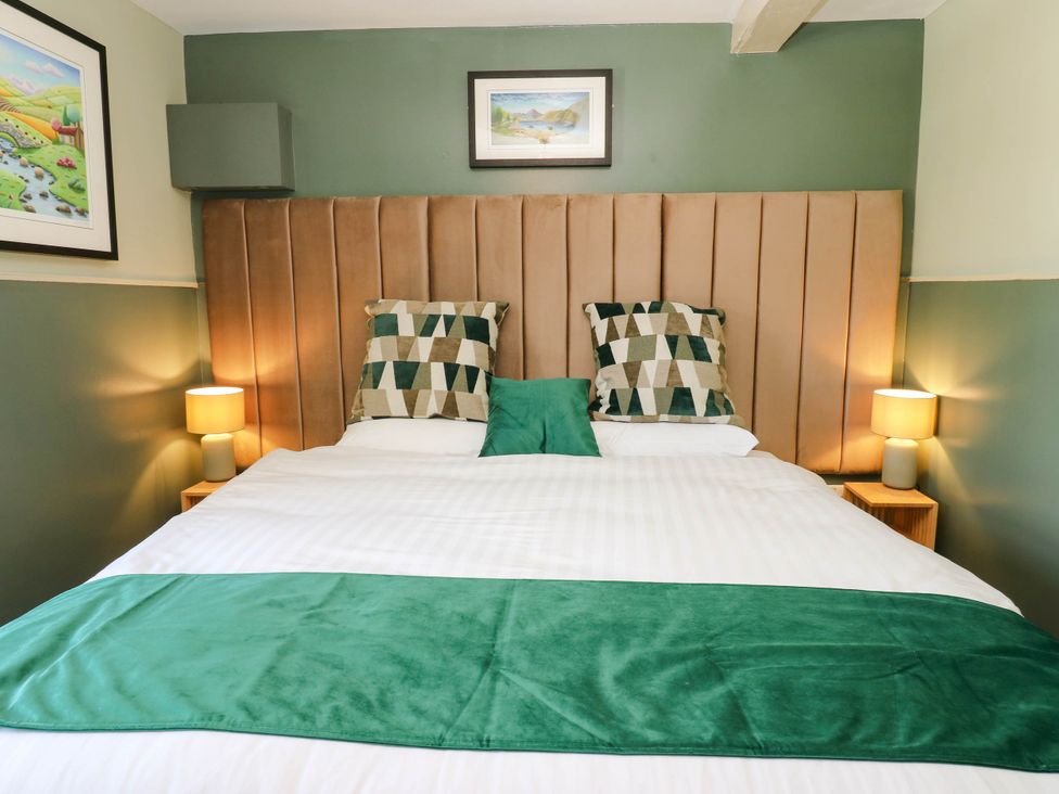 A bedroom with a bed and decorative pillows at Sands Green in Appleby-In-Westmorland