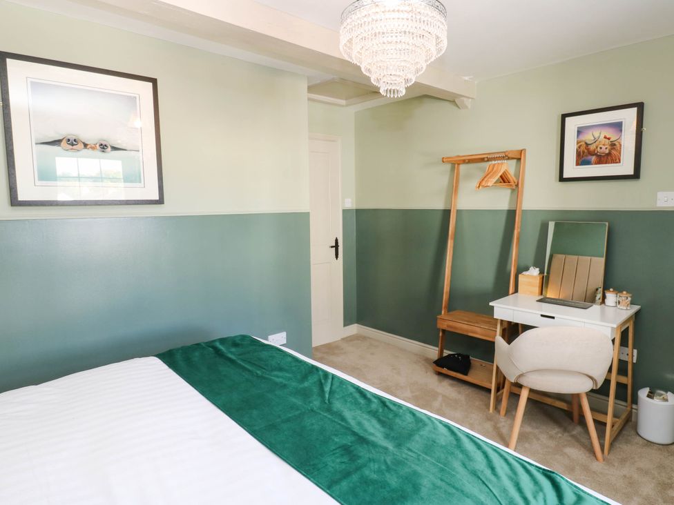 A bedroom with a bed and desk at Sands Green in Appleby-In-Westmorland