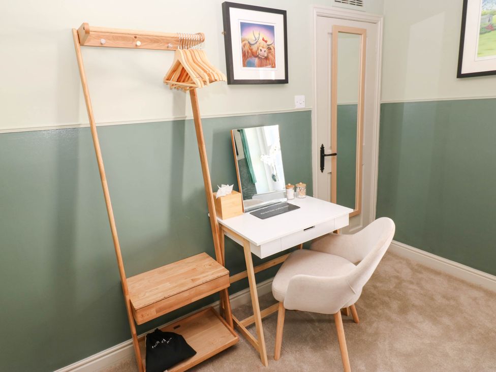 A bedroom with a clothes rack and desk at Sands Green in Appleby-In-Westmorland