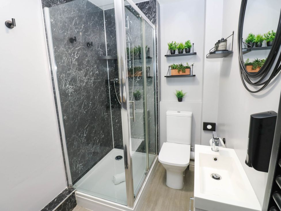 A bathroom with a shower, toilet and sink at Sands Green in Appleby-In-Westmorland