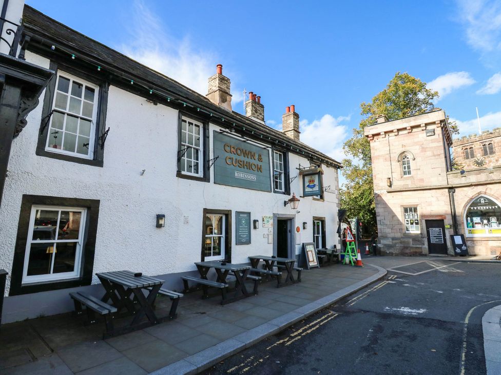 A pub exterior with outdoor seating at Crown & Cushion in Appleby-In-Westmorland