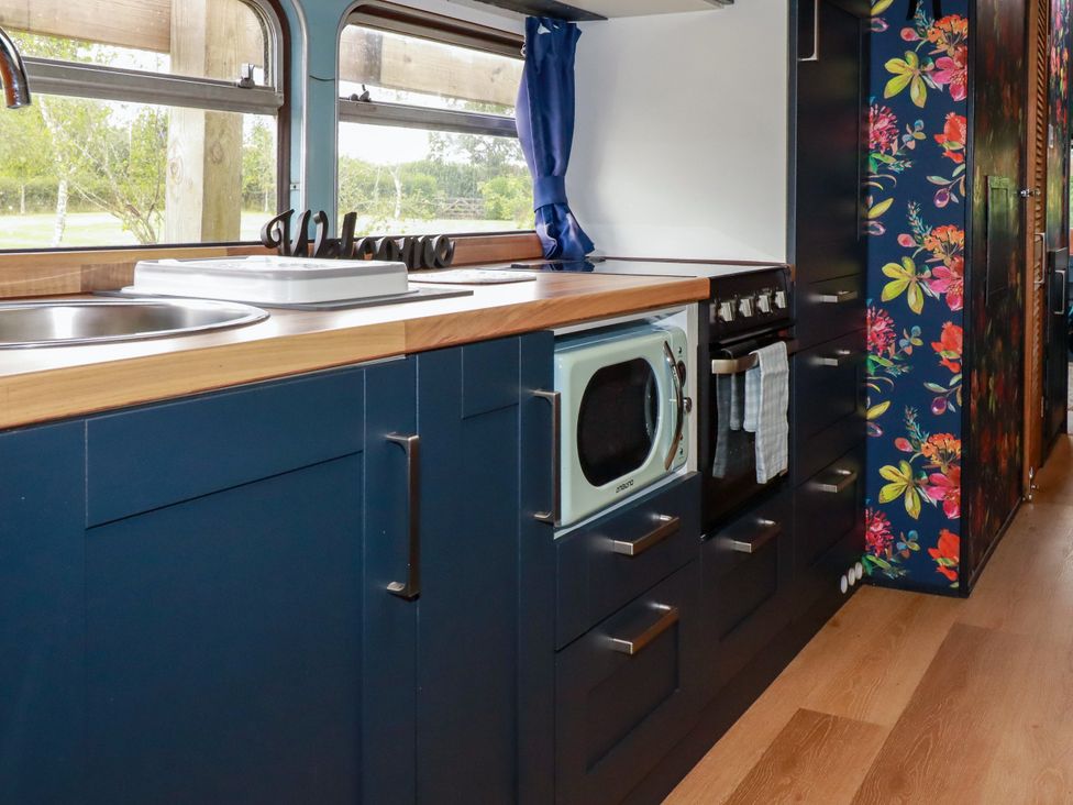A kitchen with sink and microwave at Honey Bee Bus in Menheniot