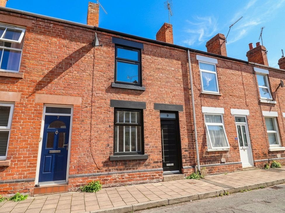 A row of brick houses with doors and windows at 9 North Street Chester